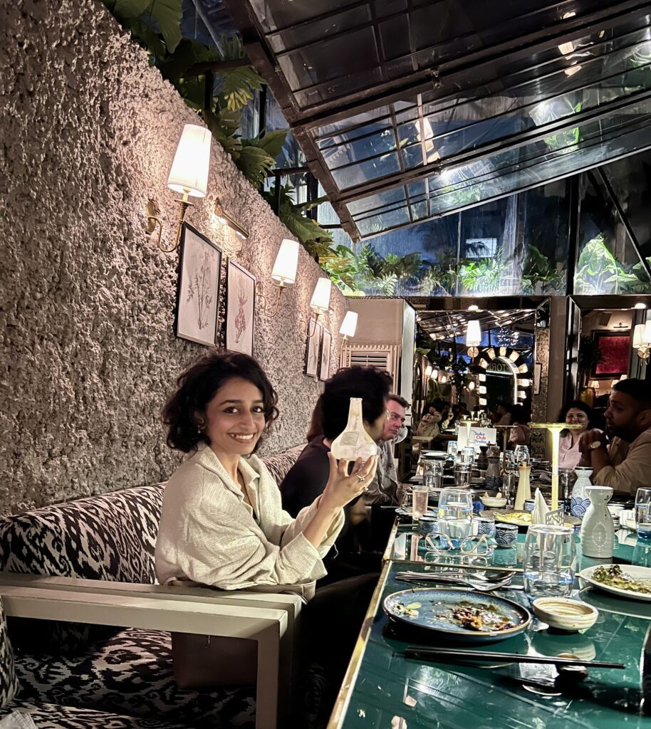 guest with homare yuzu shu bottle at sake club india tasting