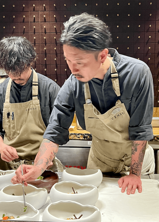 Chefs Shun Sato and Fumiyuki Kinsu assembling dishes at the New Delhi Omakase dinner.