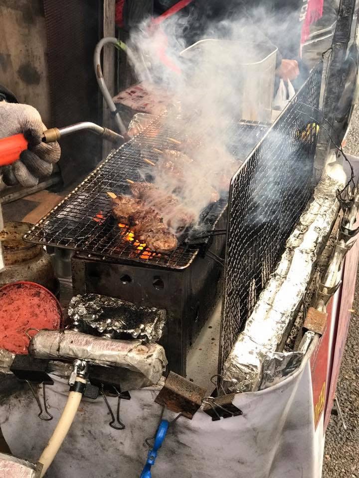Having yakitori along the streets of Kyoto near Fiahimi inari temple