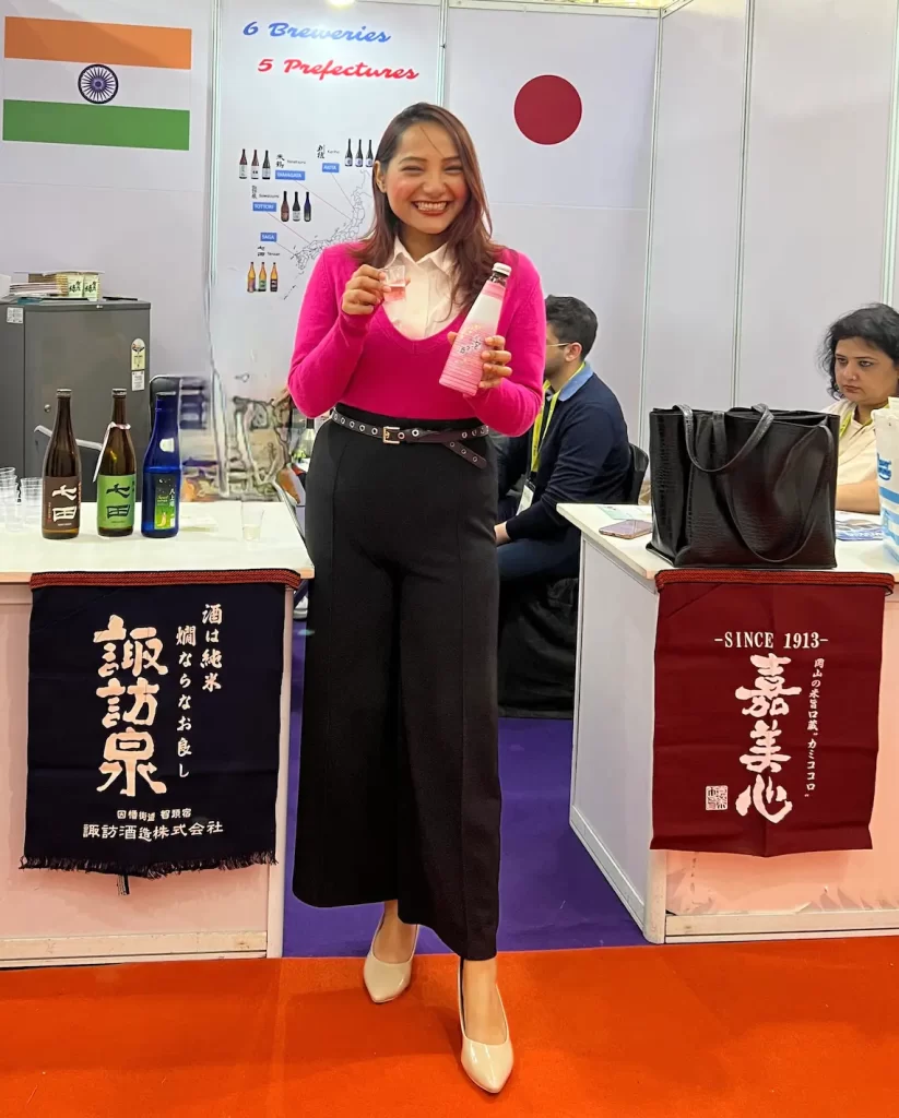 A guest enjoying Hana Hou Hou Shu sparkling sake at Sake Club India booth at VinExpo
